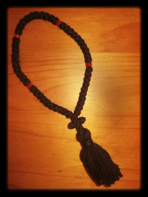 50 knots, black wool, red beads